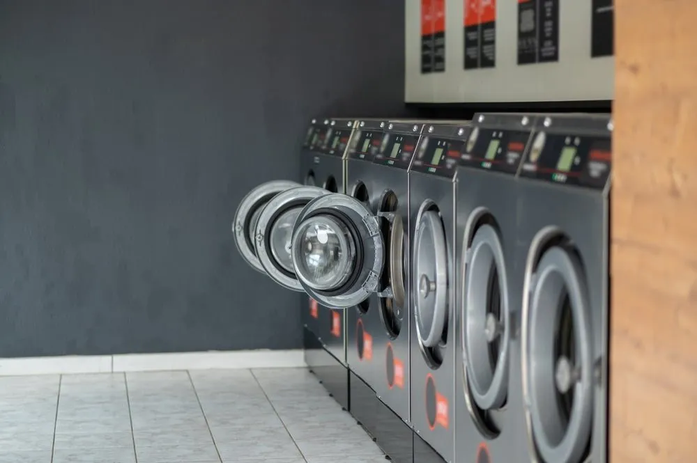 Row of commercial washing machines at the WhizzFix self-service laundry in St Julian's